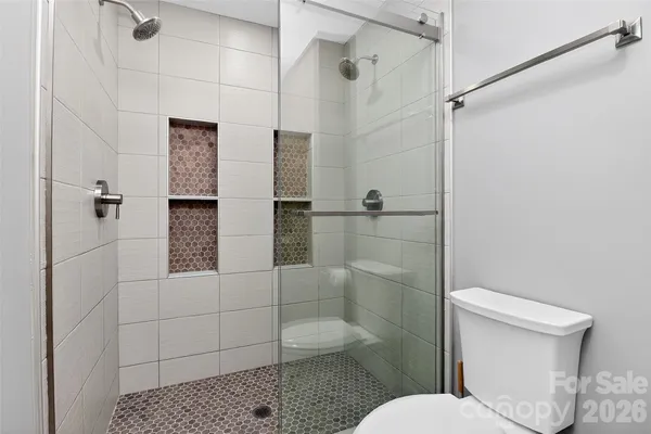 a bathroom with a toilet and shower