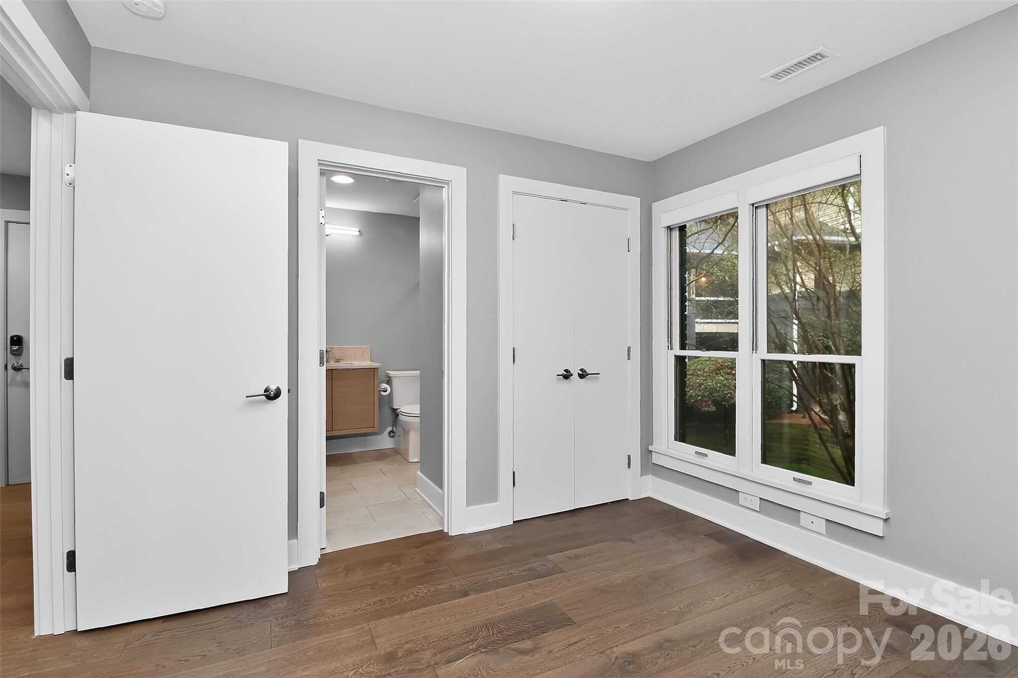 603 Queens Road, Unit B Charlotte, NC 28207 - Photo 25 of 33 a view of an empty room with glass door and a window