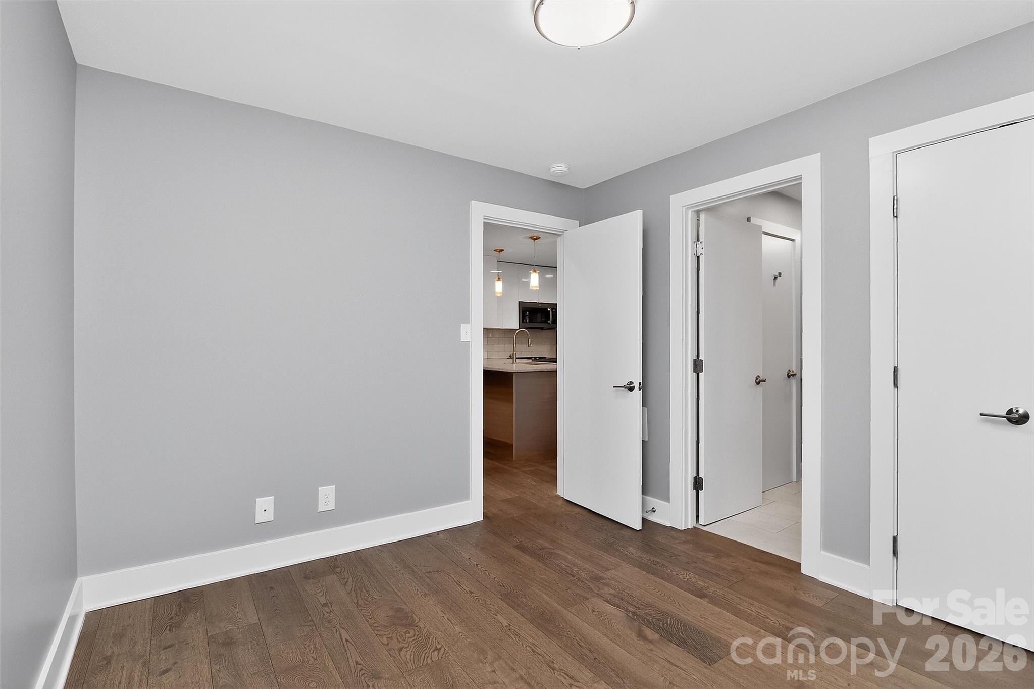 603 Queens Road, Unit B Charlotte, NC 28207 - Photo 26 of 33 a view of an empty room with wooden floor and closet