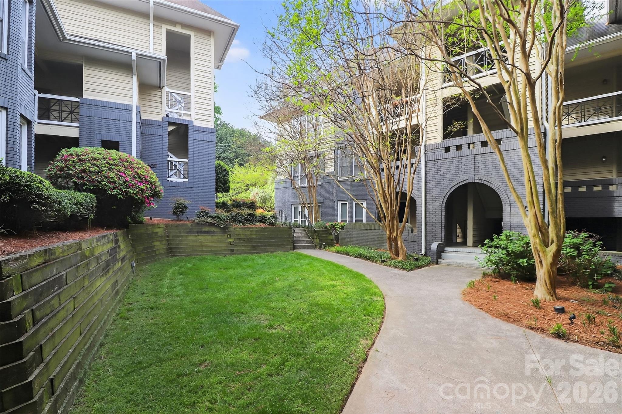 603 Queens Road, Unit B Charlotte, NC 28207 - Photo 29 of 33 a front view of a house with garden and trees