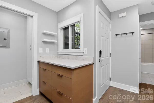 a view of kitchen with cabinets and window