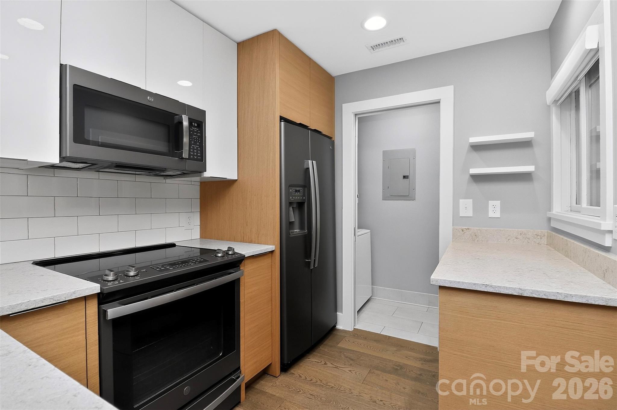 603 Queens Road, Unit B Charlotte, NC 28207 - Photo 8 of 33 a kitchen with stainless steel appliances granite countertop a stove microwave and refrigerator