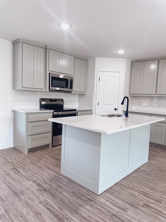 1008 East Bradshaw Road Springtown, TX 76082 - Photo 3 of 8 a kitchen with a sink a microwave and cabinets