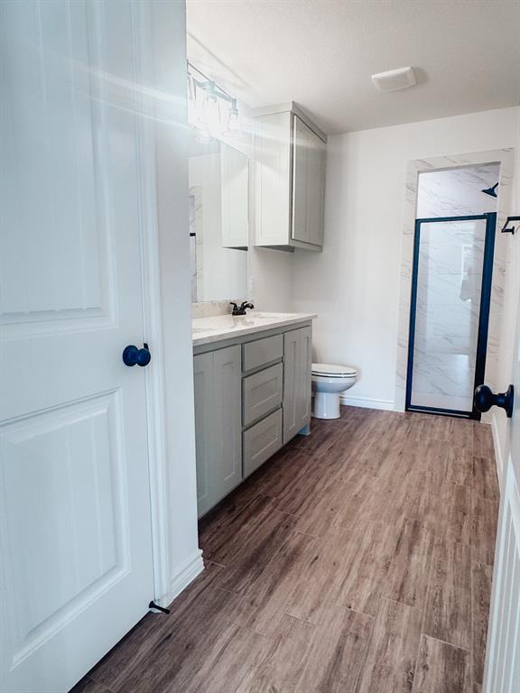 1008 East Bradshaw Road Springtown, TX 76082 - Photo 4 of 8 a kitchen with stainless steel appliances a refrigerator sink and wooden floor