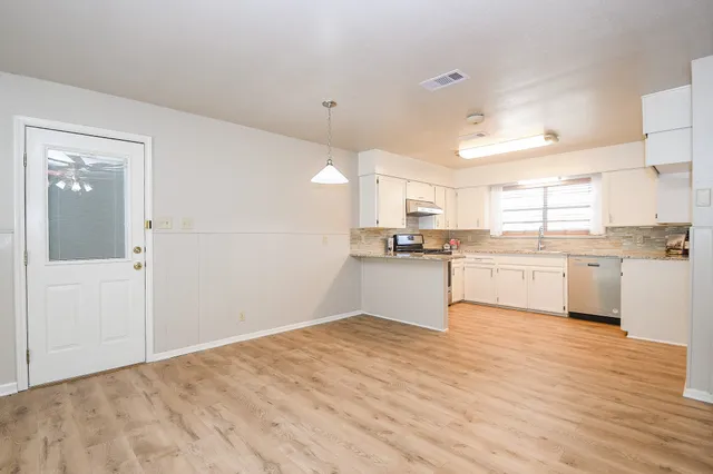 a view of kitchen with wooden floor