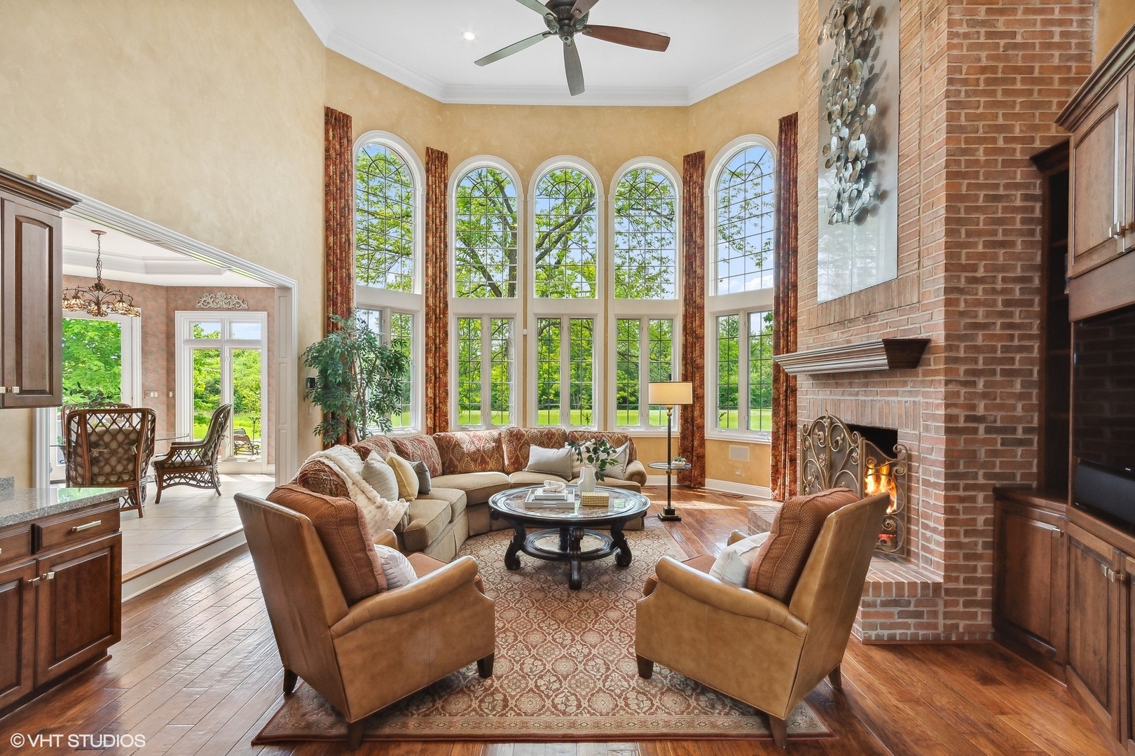 4454 Kettering Drive Long Grove, IL 60047 - Photo 15 of 49 a living room with furniture a fireplace and a large window