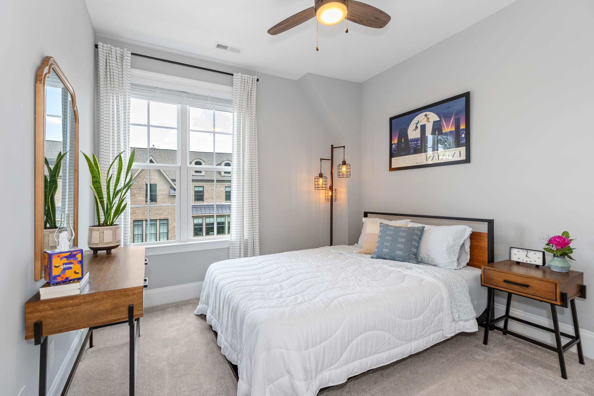 1611 Wooster Street Raleigh, NC 27607 - Photo 26 of 34 a bedroom with a bed and a chandelier