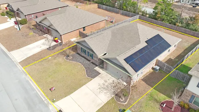 a view of an empty room with a kitchen and wooden floor