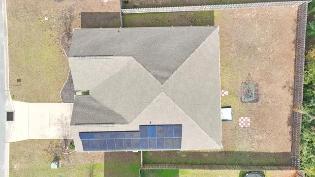 a kitchen with a sink stove top oven and wooden floor