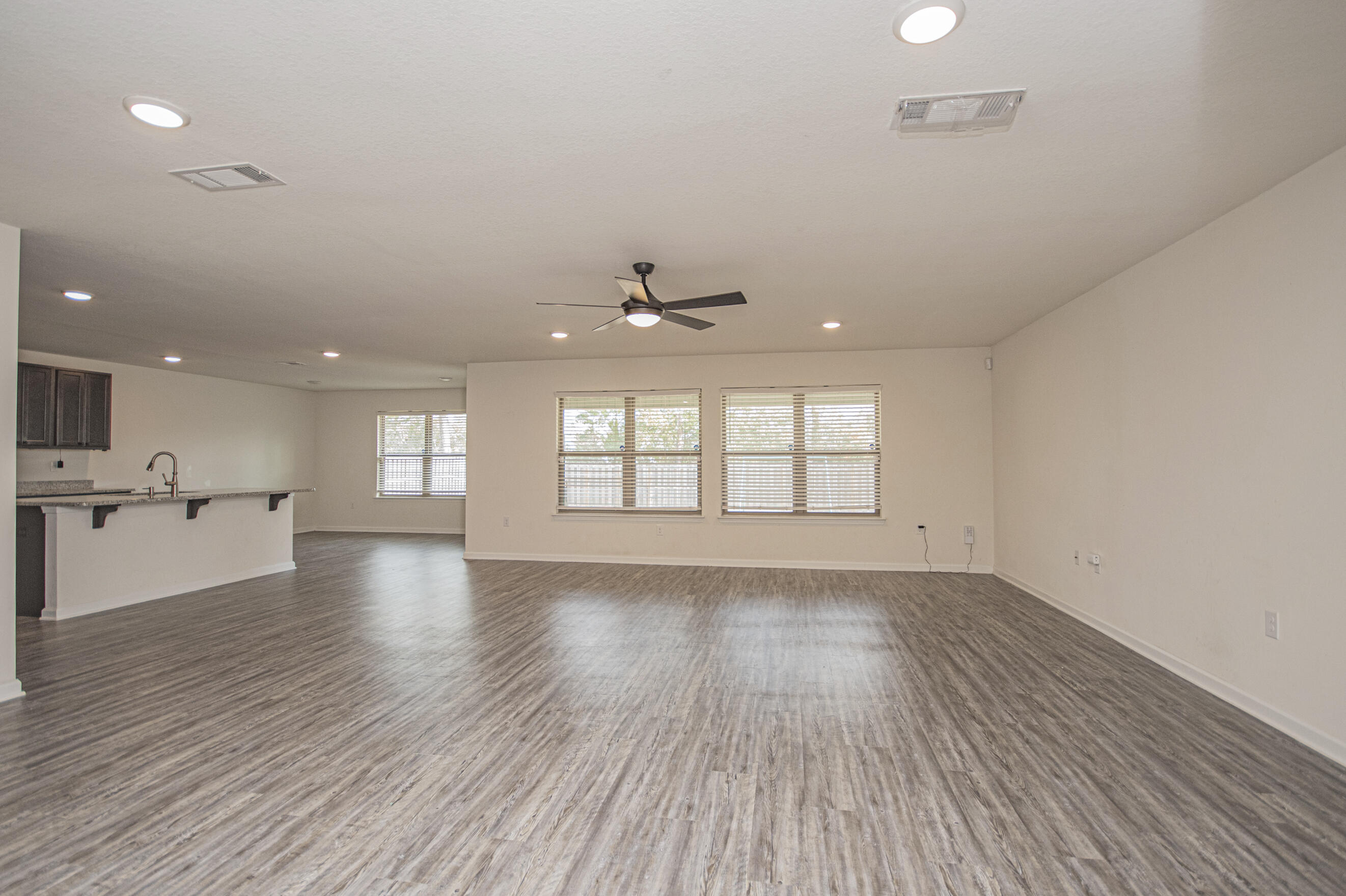 356 Merlin Court Crestview, FL 32539 - Photo 17 of 70 a view of an empty room with wooden floor and a window