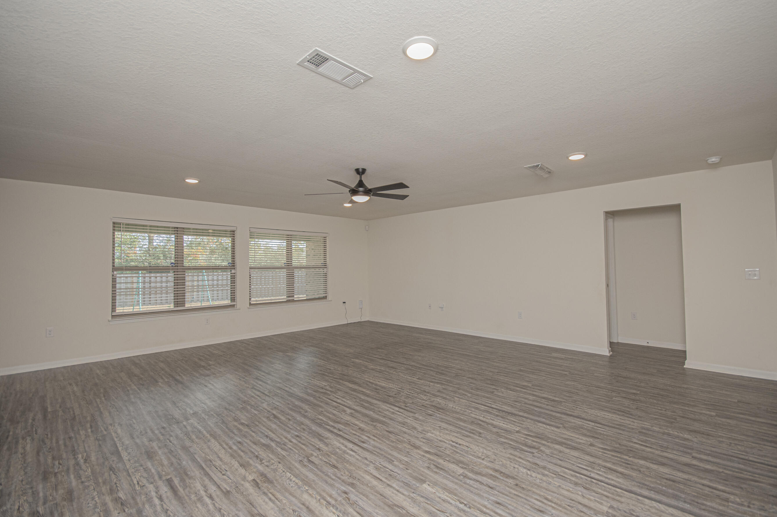 356 Merlin Court Crestview, FL 32539 - Photo 20 of 70 wooden floor in an empty room with a window