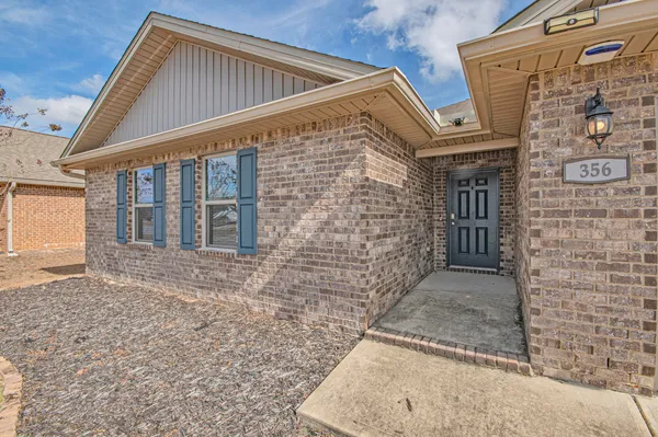 an aerial view of a house with a swimming pool