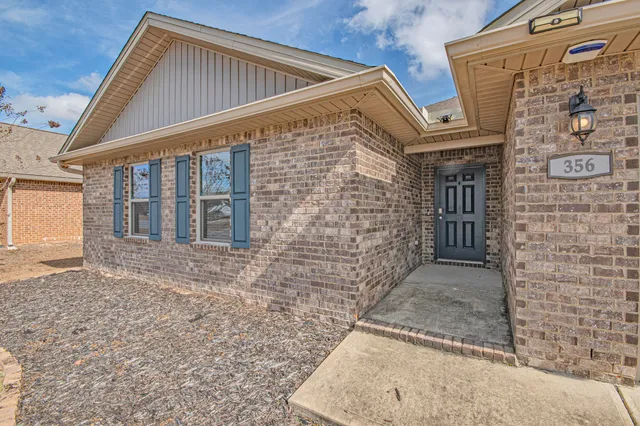 an aerial view of a house with a swimming pool