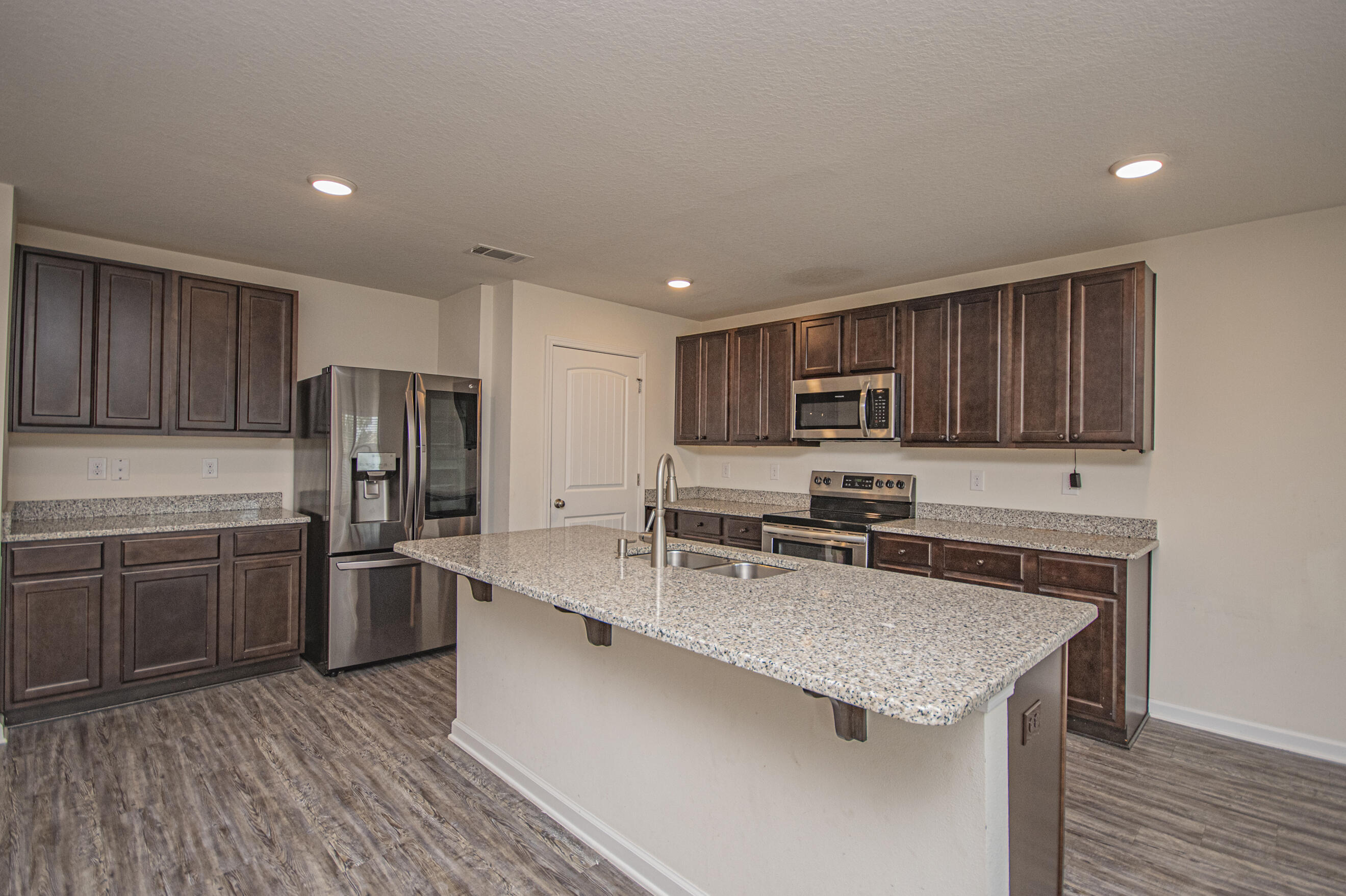 356 Merlin Court Crestview, FL 32539 - Photo 21 of 70 a kitchen with stainless steel appliances granite countertop a sink stove microwave and refrigerator