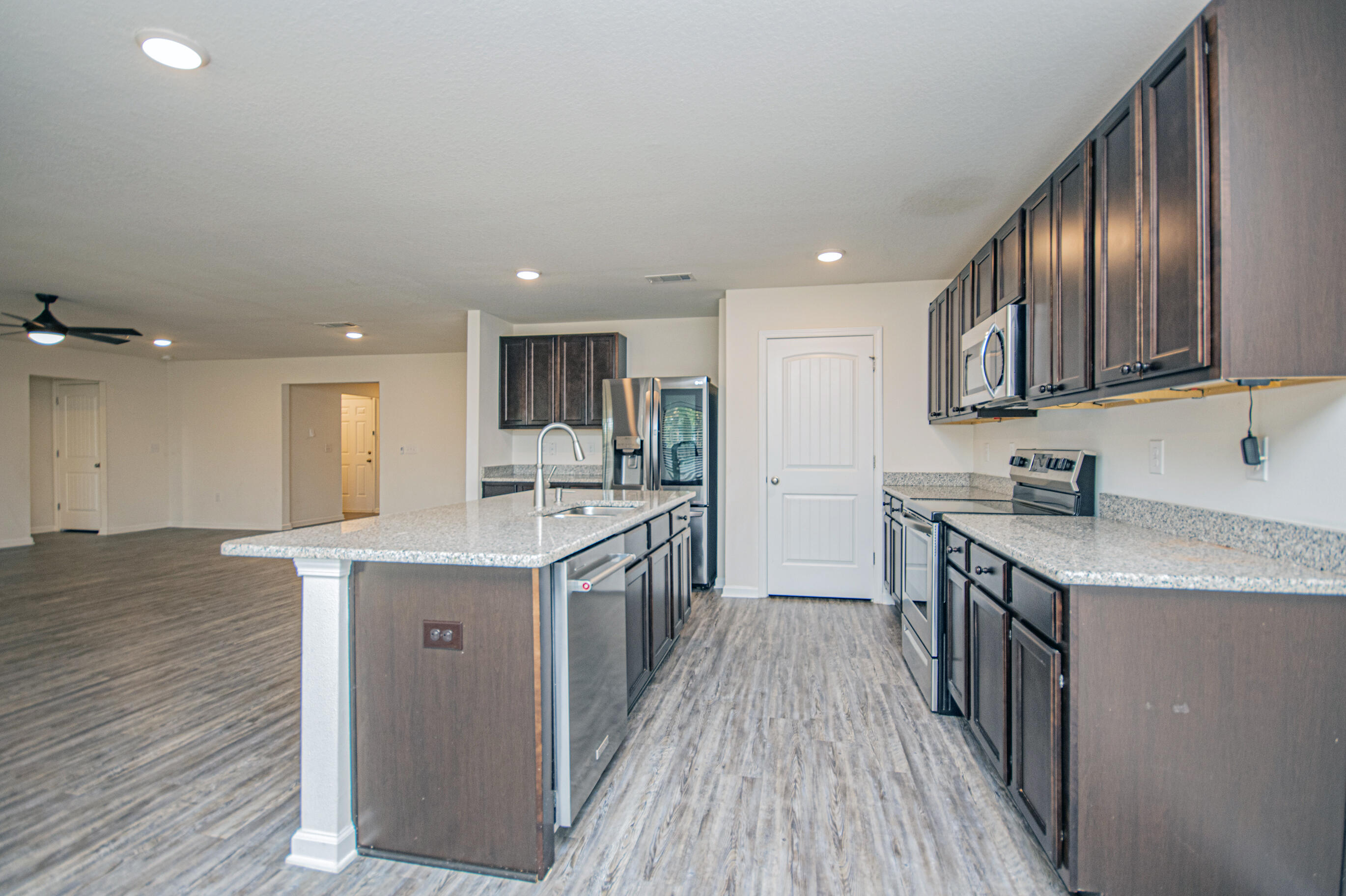 356 Merlin Court Crestview, FL 32539 - Photo 22 of 70 a kitchen with a sink stove top oven and wooden floor