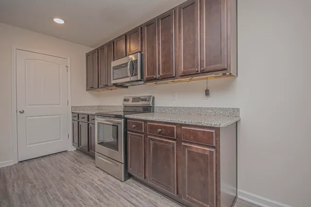 a view of a livingroom with a hardwood floor and a ceiling fan
