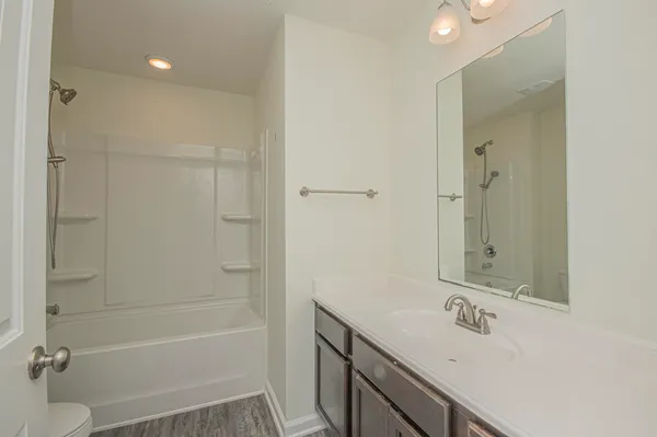 a view of a room with wooden floor