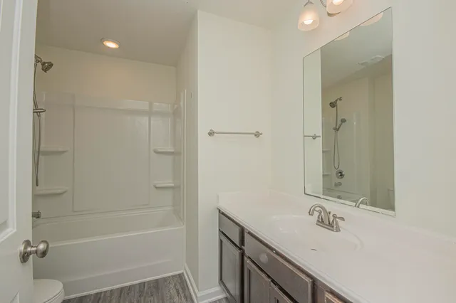 a view of a room with wooden floor