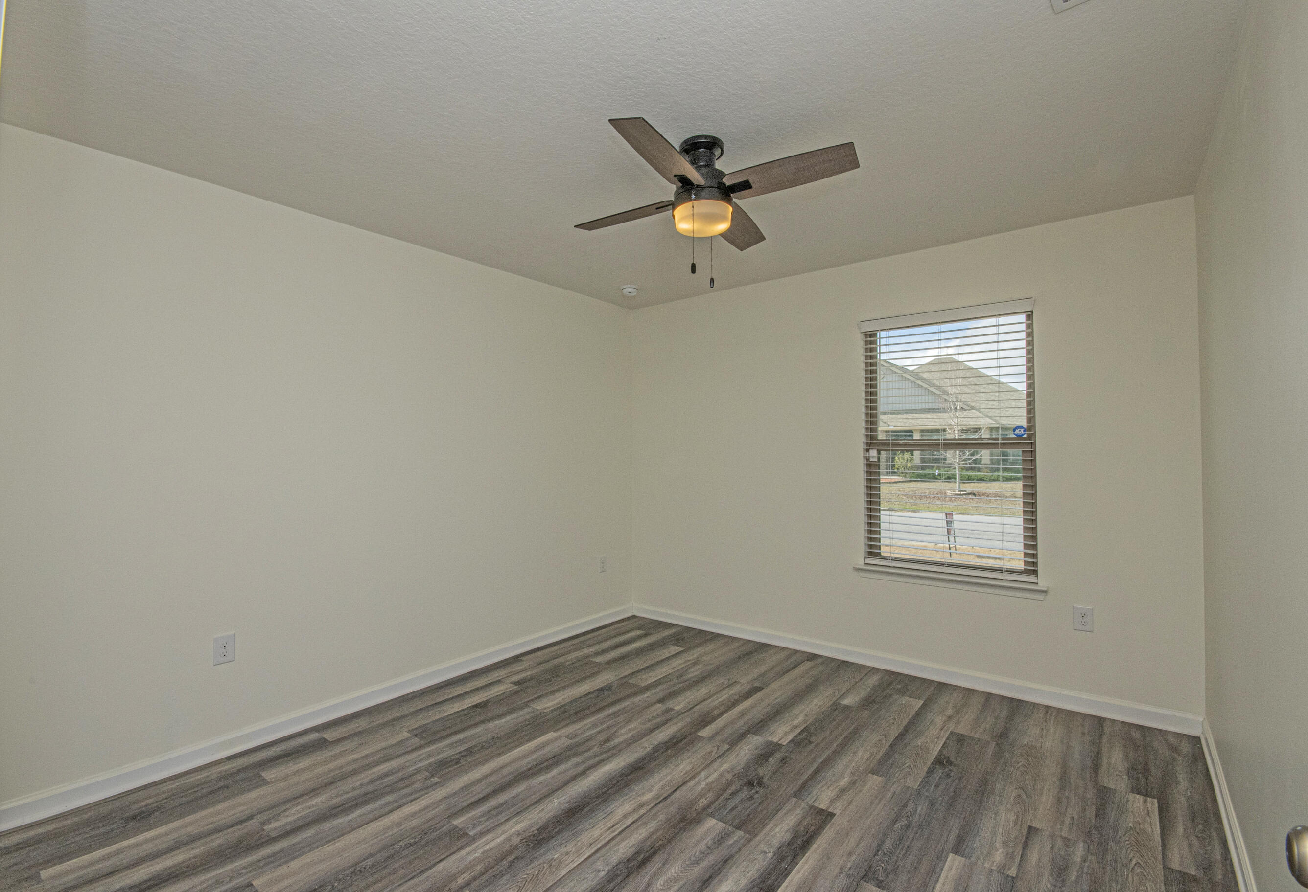 356 Merlin Court Crestview, FL 32539 - Photo 28 of 70 an empty room with a window and a ceiling fan