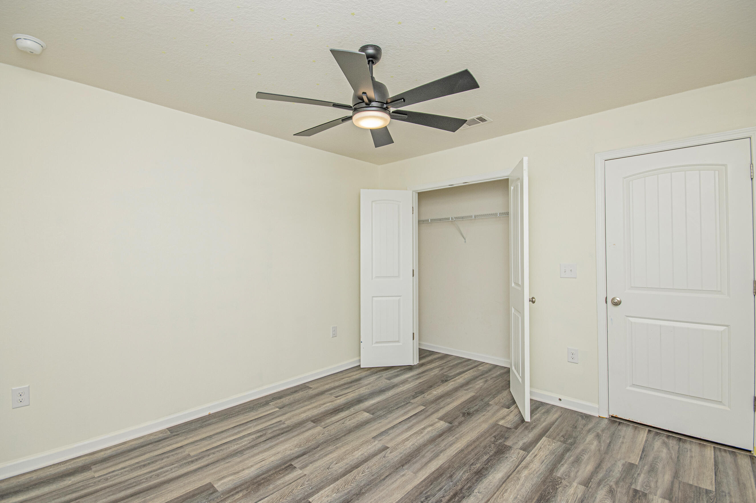 356 Merlin Court Crestview, FL 32539 - Photo 32 of 70 a view of a livingroom with a hardwood floor and a ceiling fan