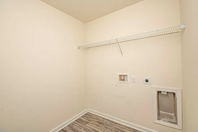 a white toilet sitting next to a white wall