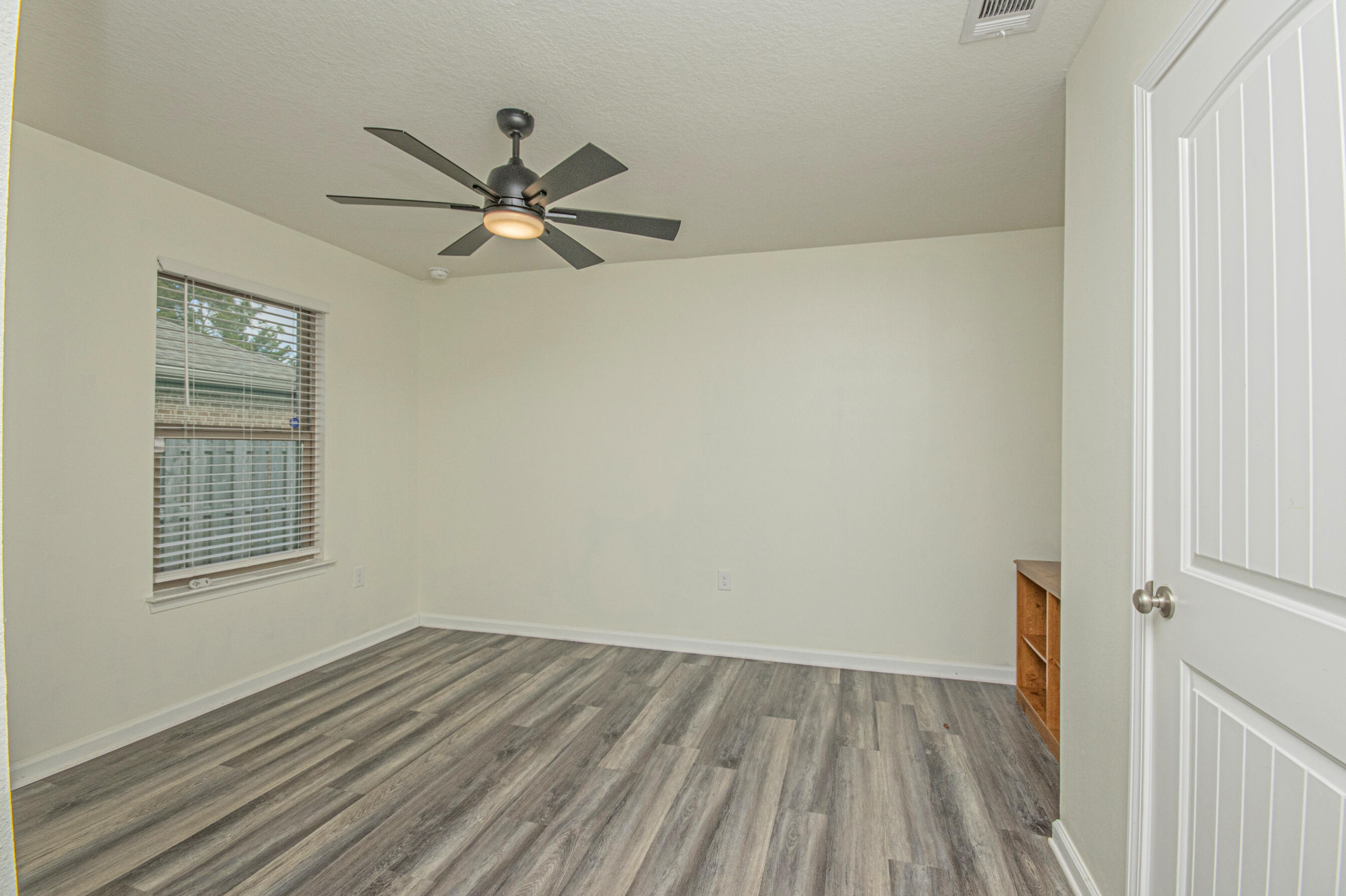 356 Merlin Court Crestview, FL 32539 - Photo 34 of 70 wooden floor in an empty room with a window