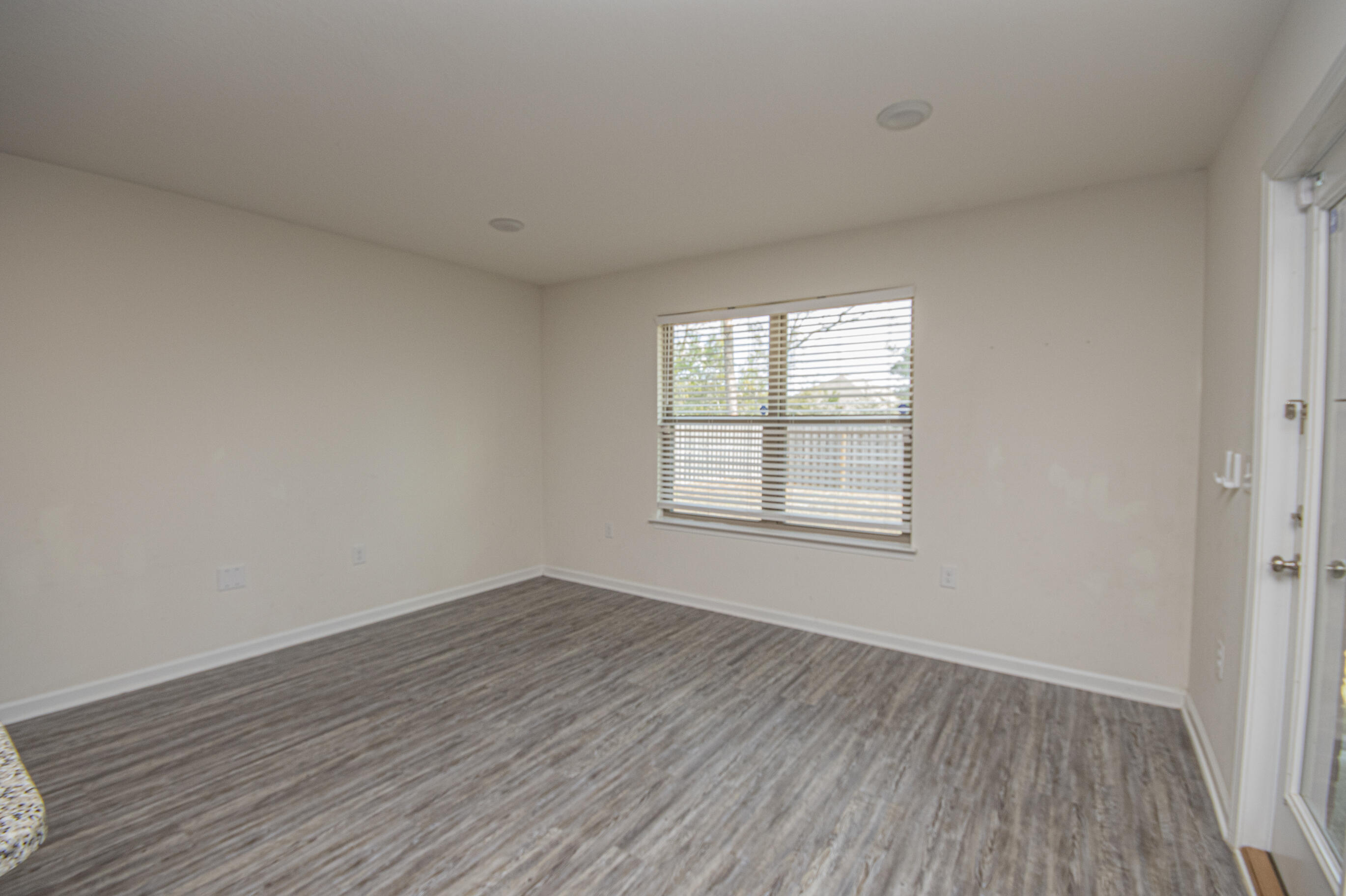 356 Merlin Court Crestview, FL 32539 - Photo 40 of 70 an empty room with wooden floor and windows