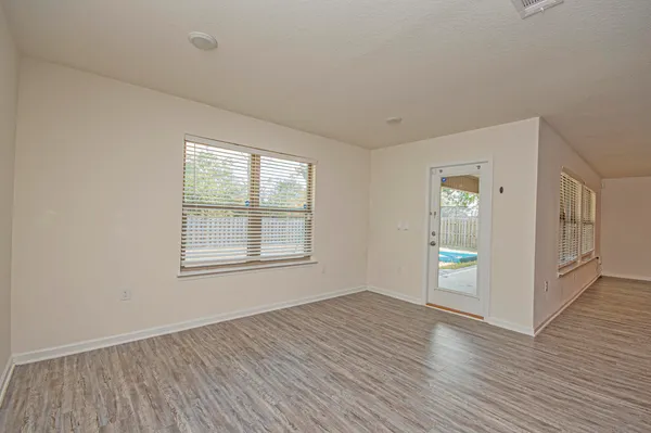 a backyard of a house with table and chairs