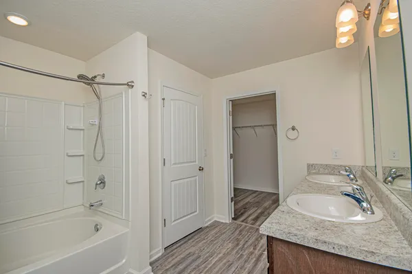 an aerial view of a house with swimming pool and large trees