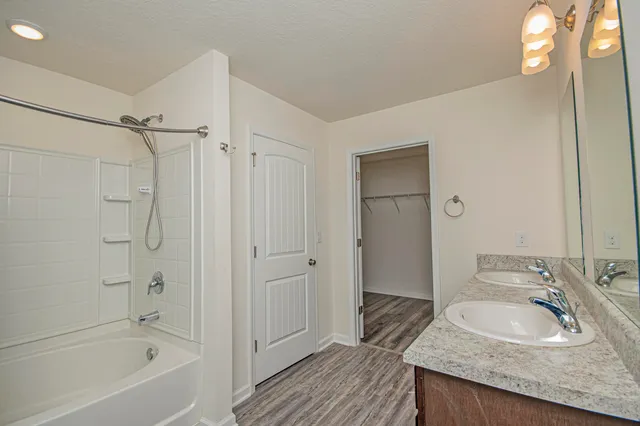 an aerial view of a house with swimming pool and large trees