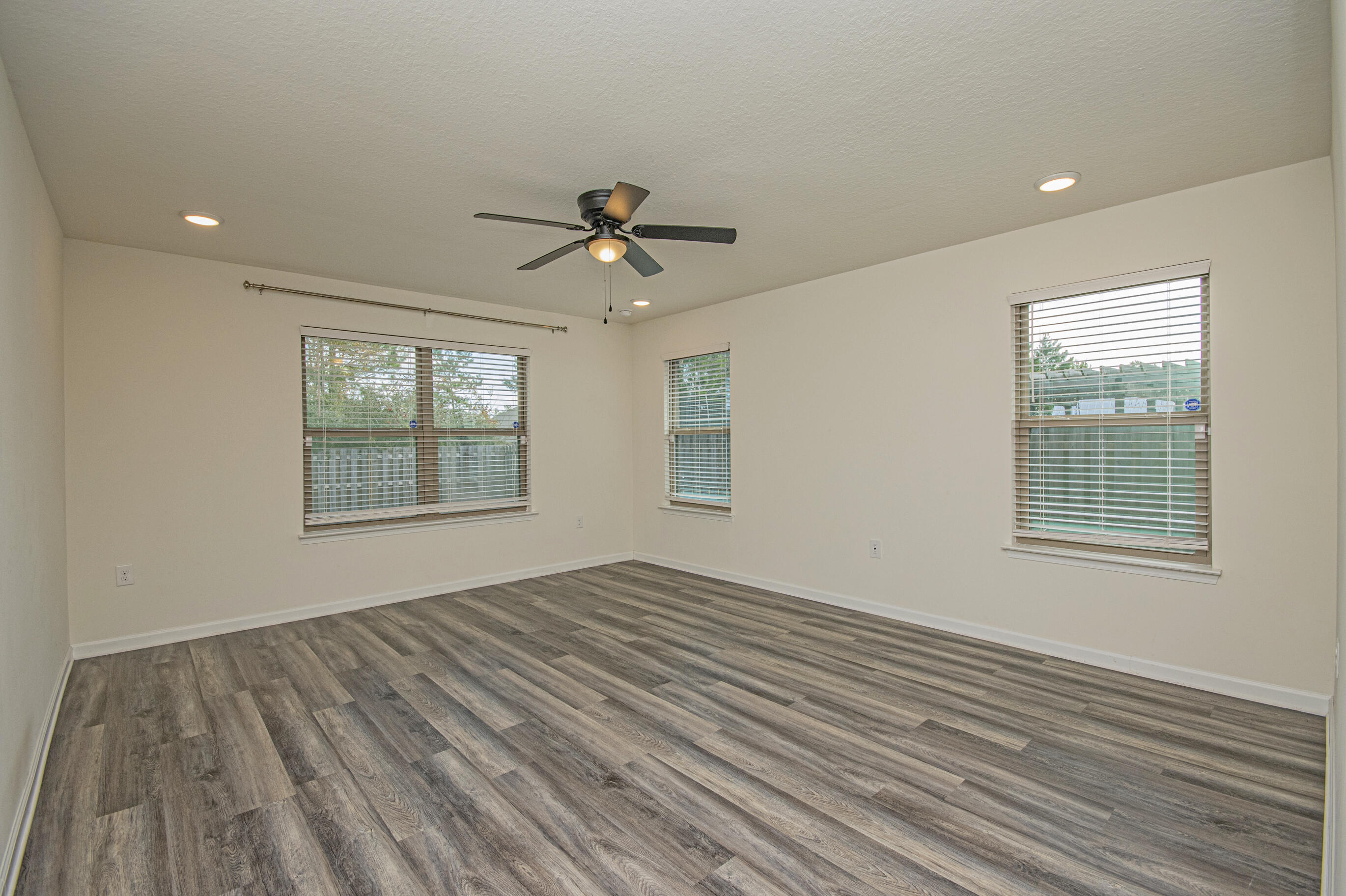 356 Merlin Court Crestview, FL 32539 - Photo 48 of 70 a view of empty room with wooden floor and fan