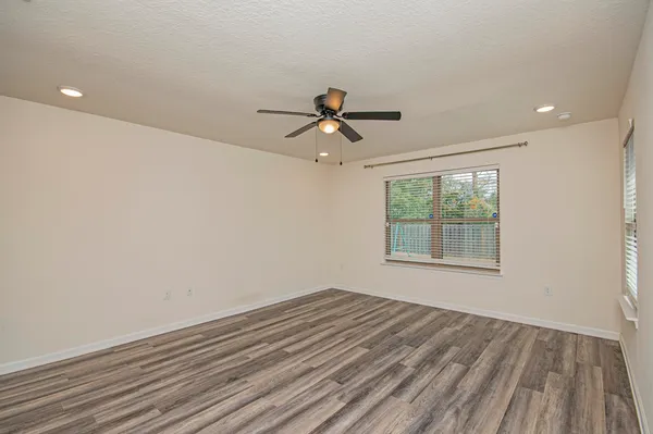 a view of a livingroom with furniture and floor to ceiling window