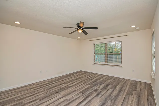 a view of a livingroom with furniture and floor to ceiling window