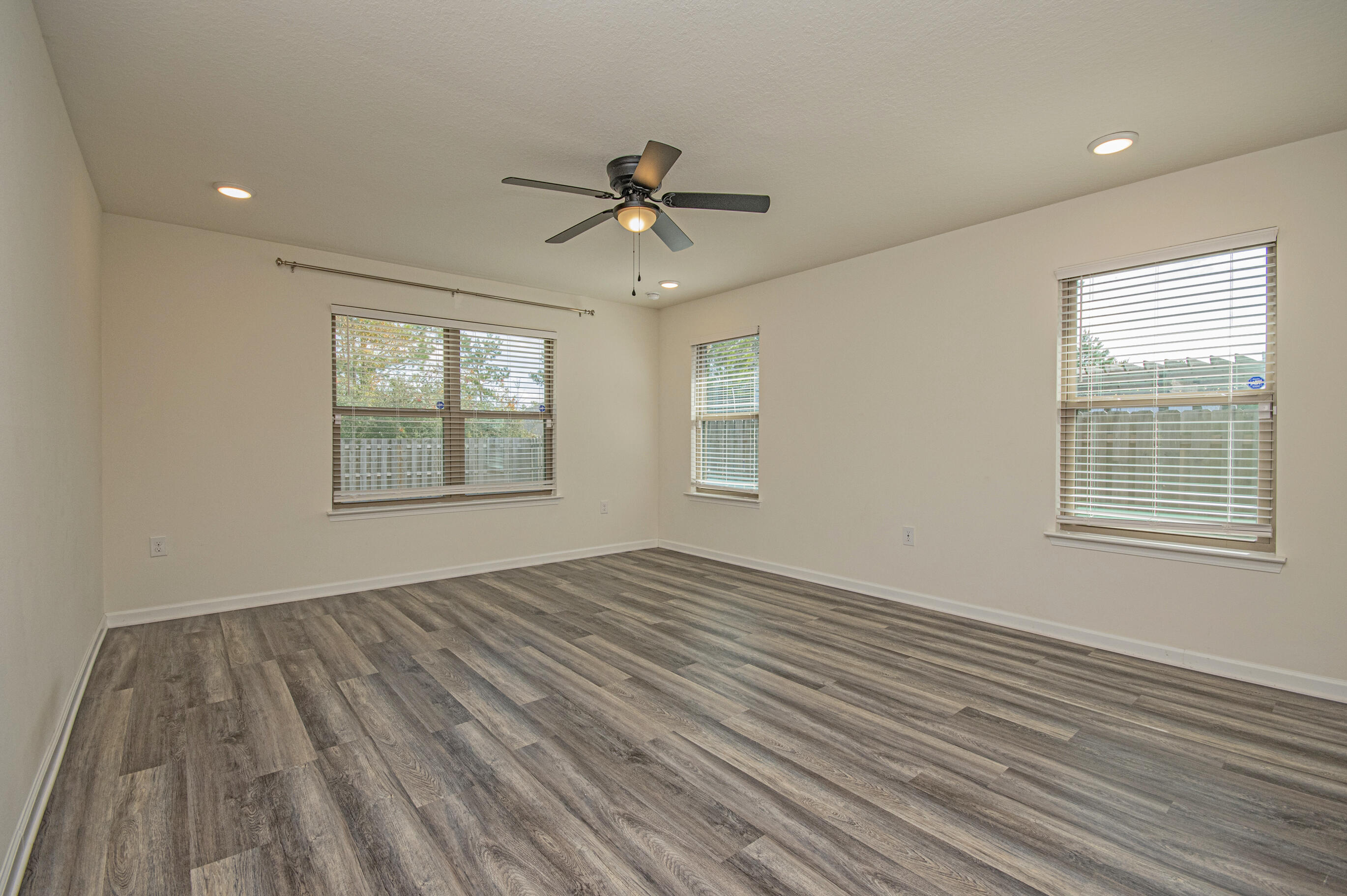 356 Merlin Court Crestview, FL 32539 - Photo 50 of 70 a view of an empty room with wooden floor and a window
