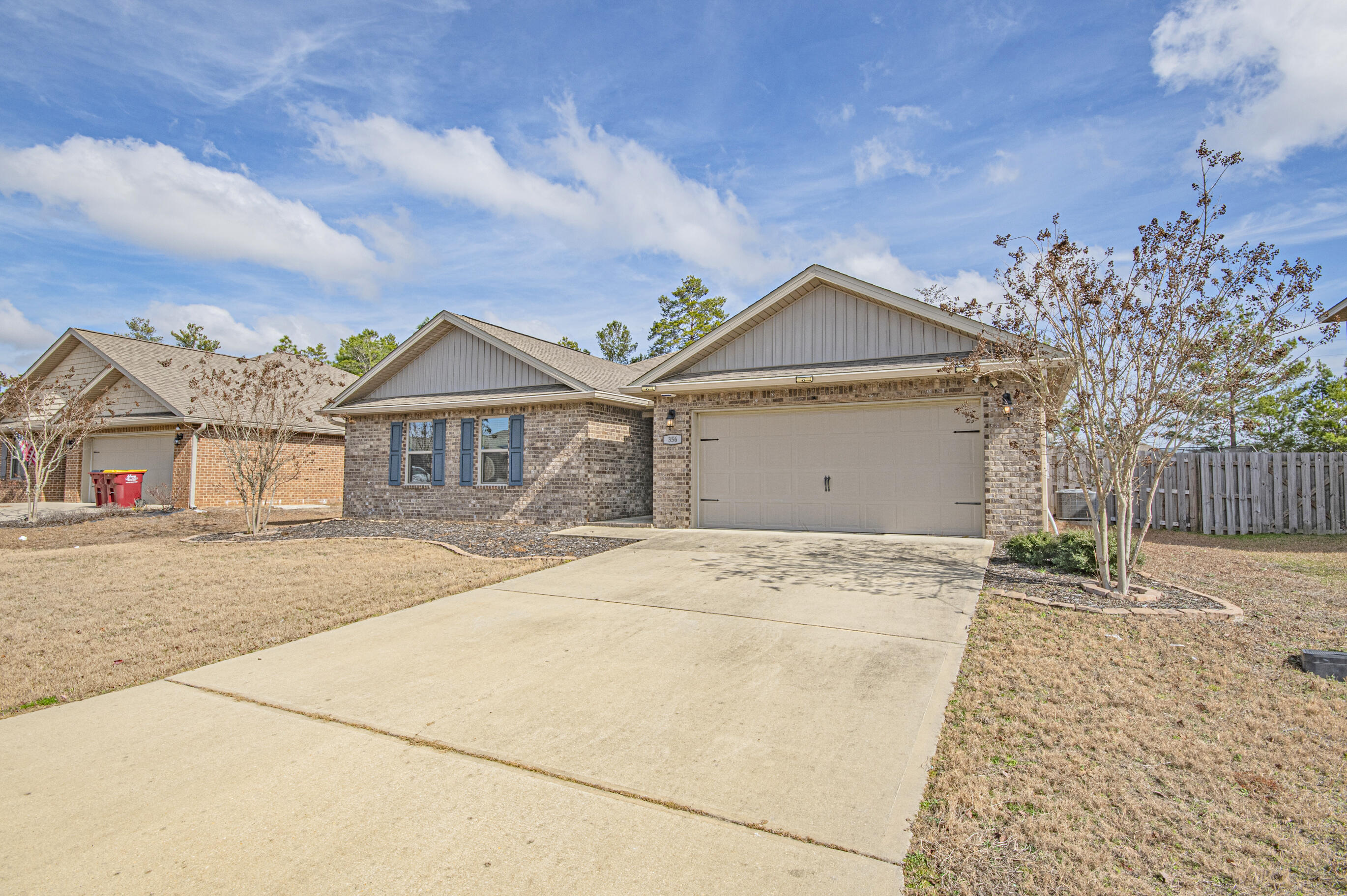 356 Merlin Court Crestview, FL 32539 - Photo 58 of 70 a front view of a house with a yard and garage