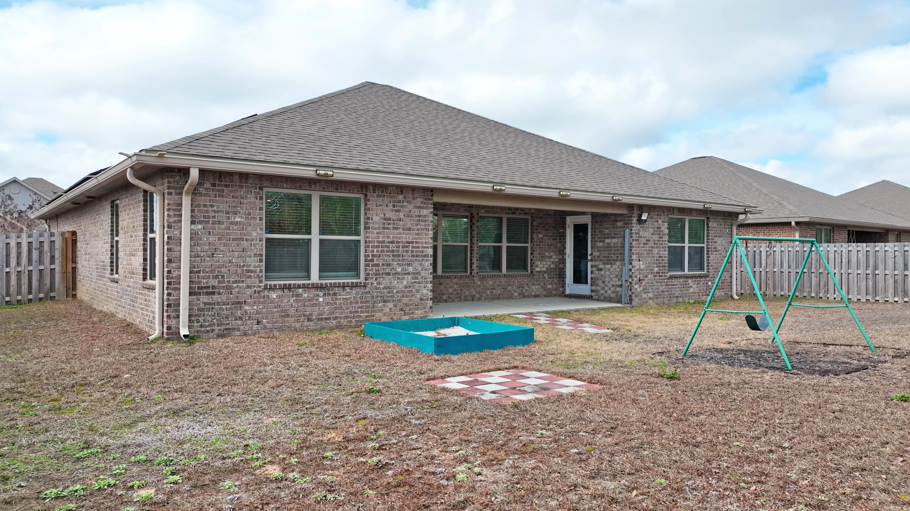 356 Merlin Court Crestview, FL 32539 - Photo 9 of 70 a house that has a table and chairs in front of it