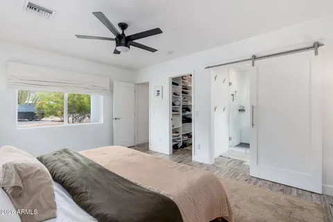 a bedroom with a bed and a window