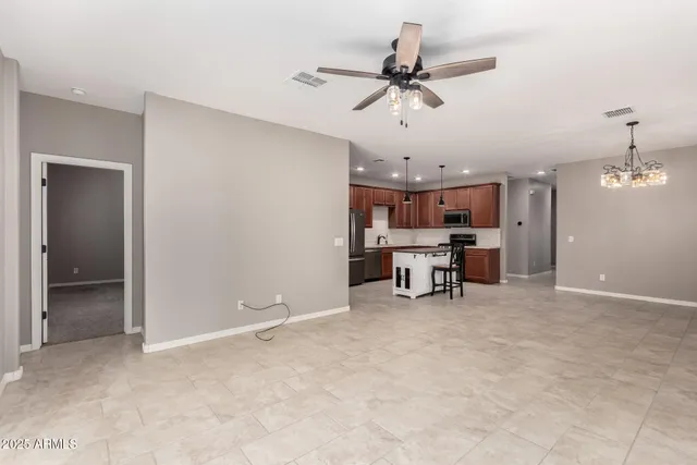 a view of a livingroom with furniture and a ceiling fan
