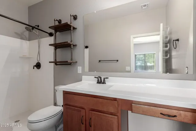 a bathroom with a sink toilet and shower