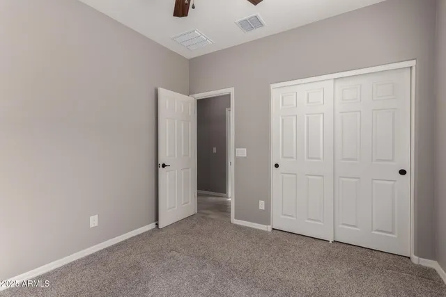 an empty room with closet area