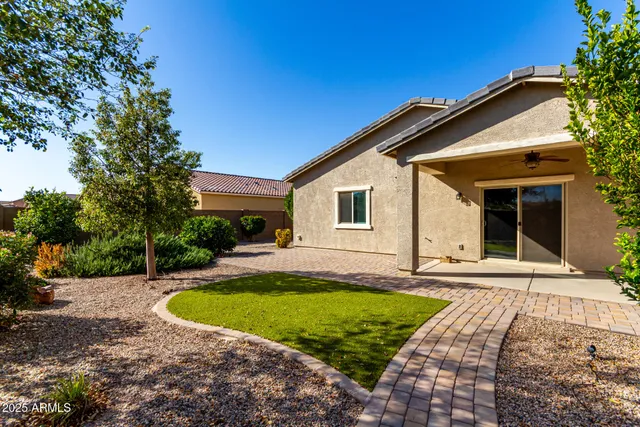 a view of a house with swimming pool and yard