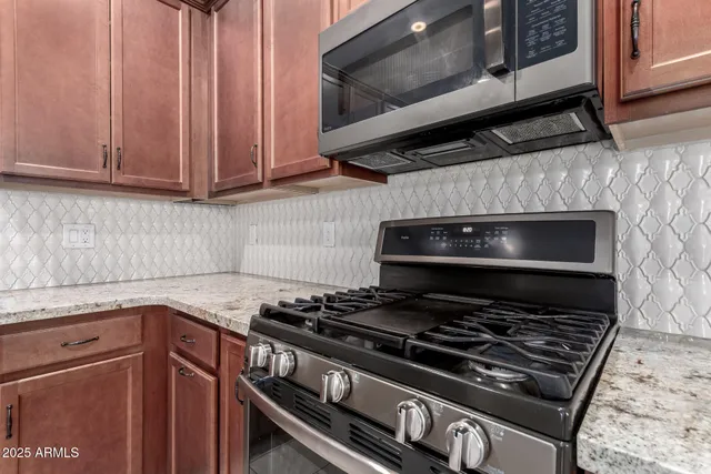 a stove top oven sitting inside of a kitchen