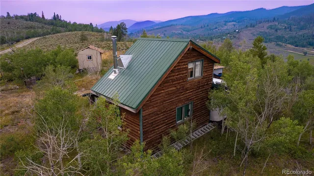 a view of a house with a yard and mountain view