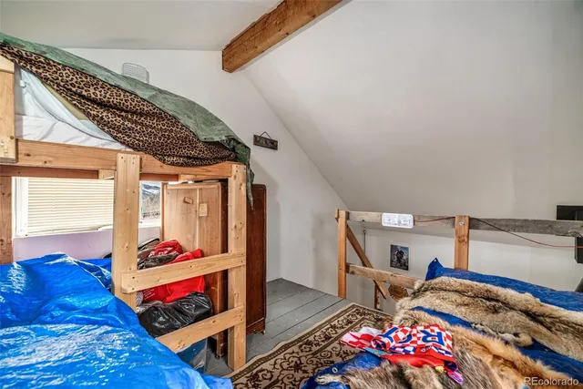 a bedroom with bed and a window