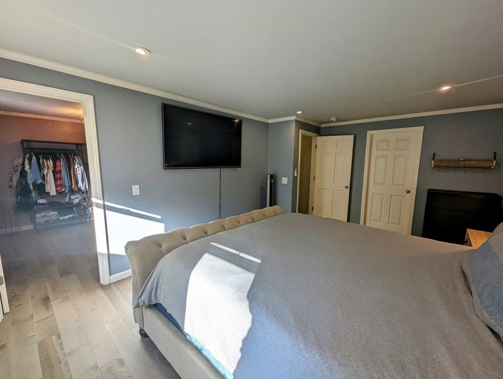 93 Blood Road Charlton, MA 01507 - Photo 11 of 42 a bedroom with a bed and a flat screen tv