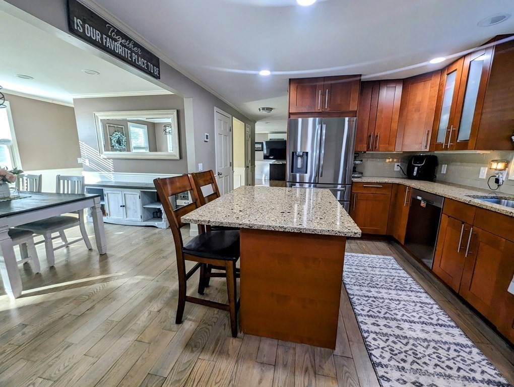 93 Blood Road Charlton, MA 01507 - Photo 3 of 42 a kitchen with stainless steel appliances granite countertop a kitchen island hardwood floor sink stove dining table and chairs
