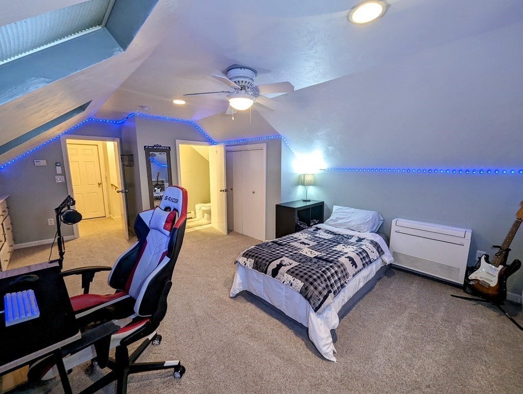 93 Blood Road Charlton, MA 01507 - Photo 32 of 42 a spacious bedroom with a bed a chandelier and dresser