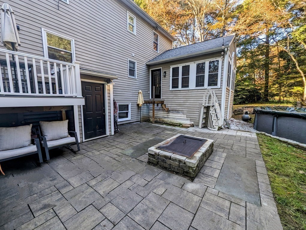 93 Blood Road Charlton, MA 01507 - Photo 6 of 42 a view of a patio with a table and chairs and a barbeque