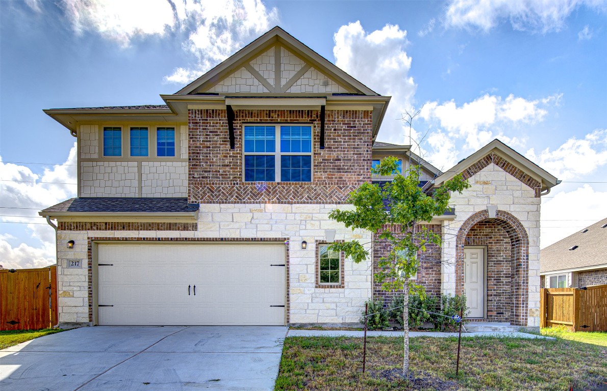 217 Pelican Bay Circle Kyle, TX 78640 - Photo 1 of 1 a front view of a house with a yard garage and outdoor seating