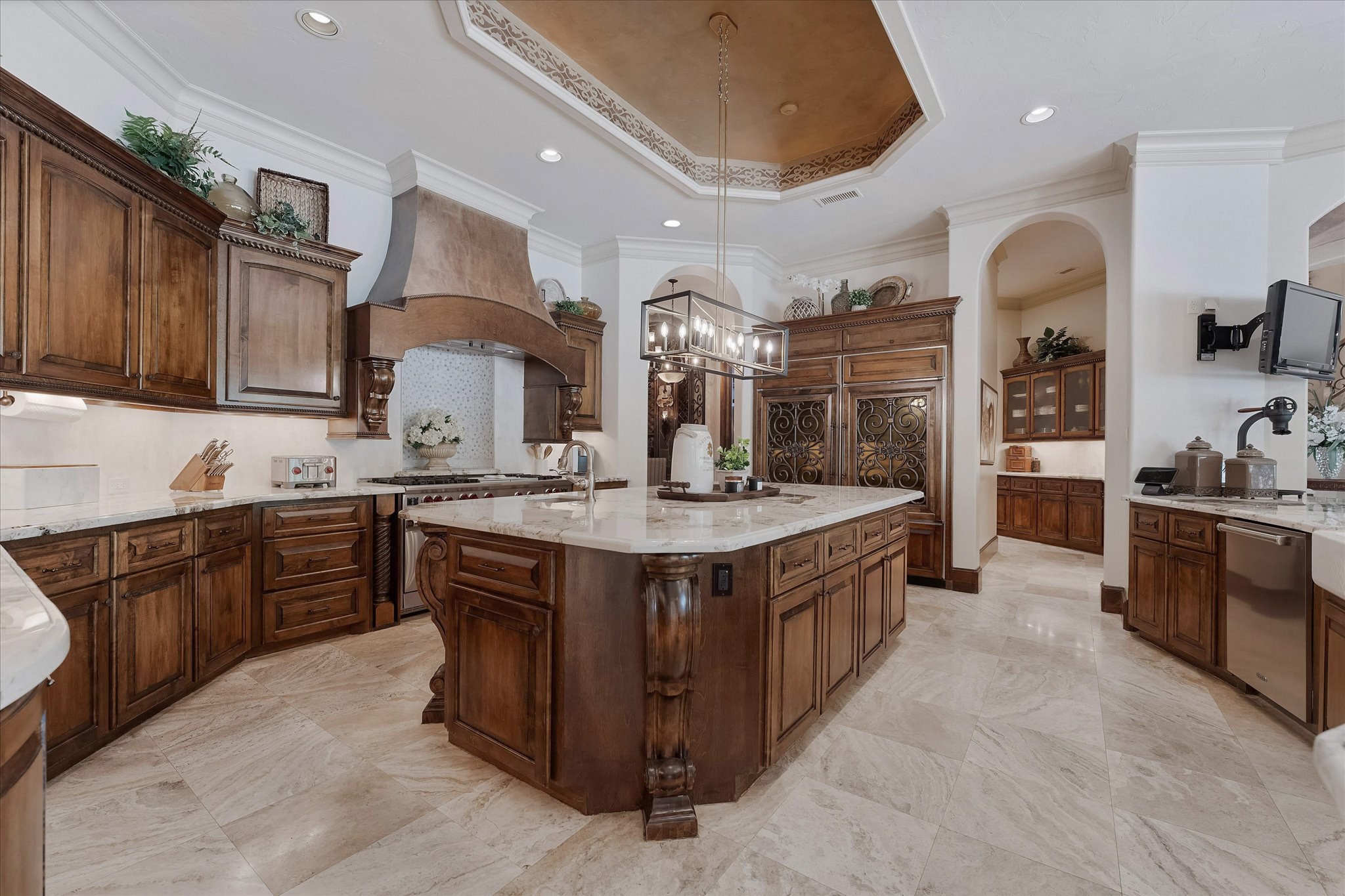 28322 Meadow Forest Magnolia, TX 77355 - Photo 12 of 50 The kitchen boasts a 60" gas range with double ovens, warming drawer, two full-sized stainless dishwashers, a stainless steel ice maker, and dual Sub-Zero refrigerators with freezer drawers. The oversized walk-in pantry features a full-size SubZero refrigerator. Alpine granite countertops, an oversized center island, recessed speakers and lighting, pendant light fixtures, custom crown molding, travertine floors, a tray ceiling with cove lighting, and under-cabinet lighting.